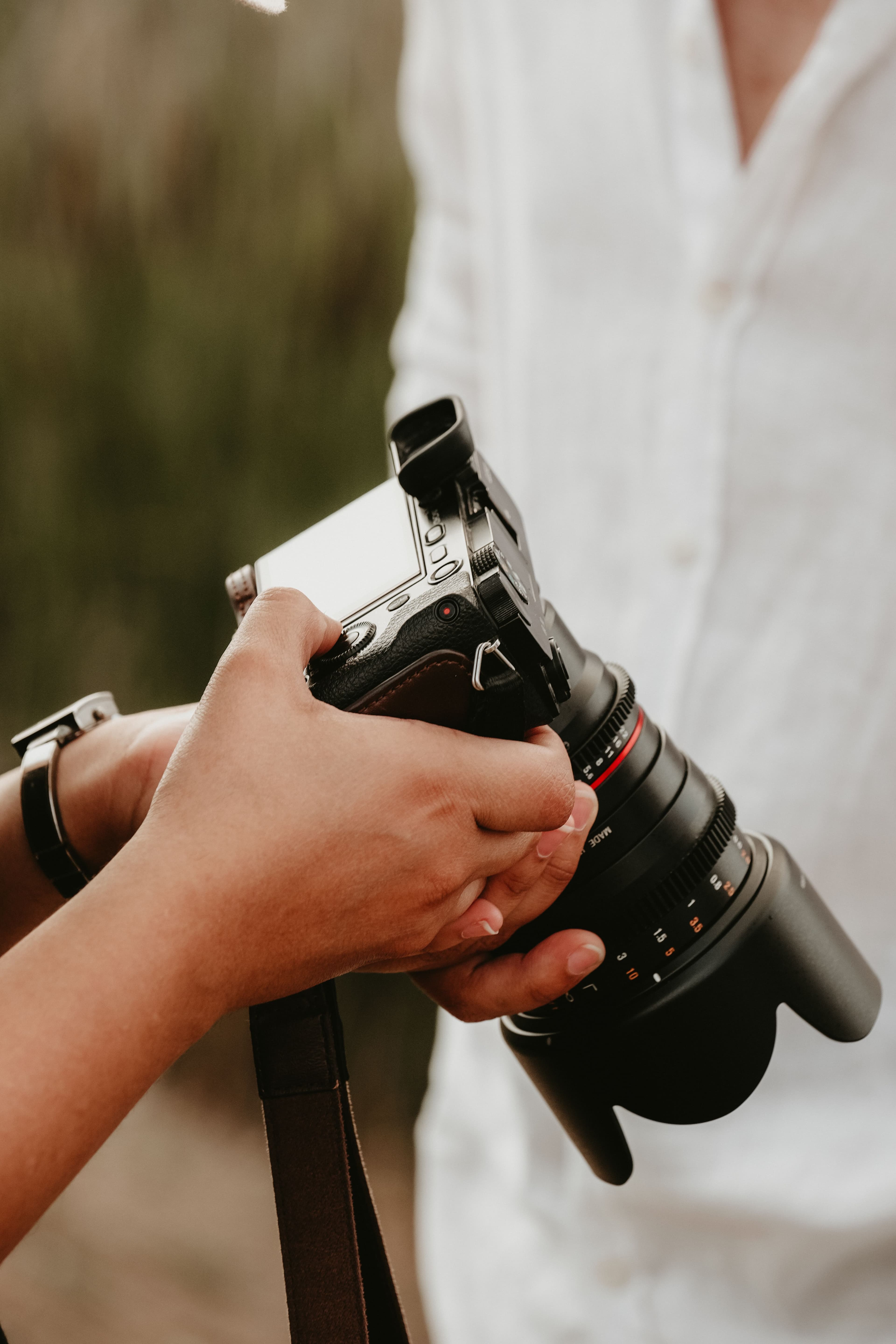 A photographer adjusting a professional camera